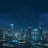 City skyline at night overlaid with a digital network graphic, representing connected technology and business innovation.