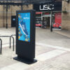 49 inch freestanding outdoor digital totem installed outside a shopping precinct, displaying trainer advertising.