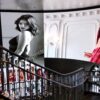 Curved LED display installed above a spiral staircase, showing large-scale fashion imagery that follows the sweeping architectural line of the stairwell.