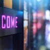 Illuminated LED sign displaying "WELCOME" in pink text against a blurred, softly lit night-time background.