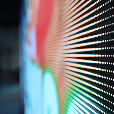 Close-up of illuminated WLR Series transparent LED screen strips, showing vivid colour content and the transparent gaps between rows.
