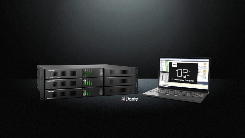 Rack-mounted Bose PowerShareX smart power amplifiers with Dante networking, shown alongside a laptop running ControlSpace Designer software.