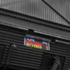 LED text display mounted beneath an industrial hopper, showing vehicle plate and weight information for site logistics.