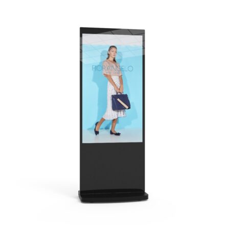 Black 50-inch touchscreen freestanding digital poster displaying a fashion brand advertising campaign.