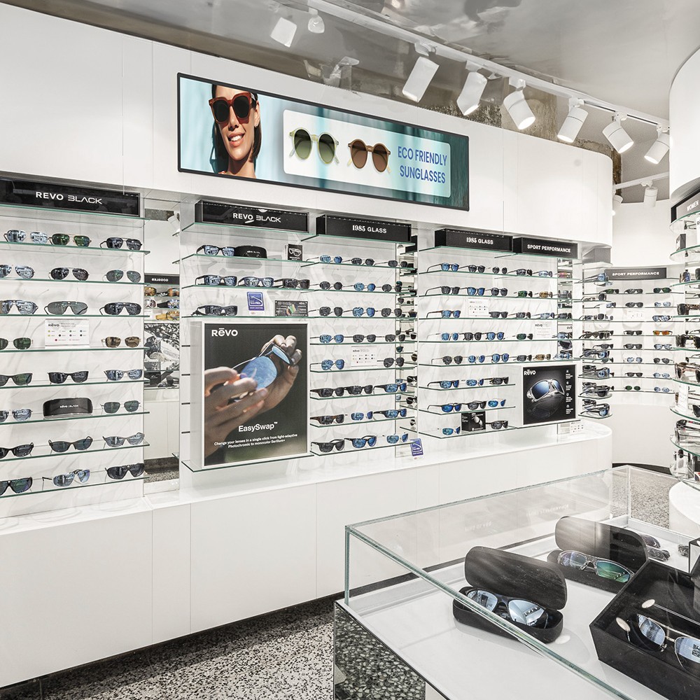 76-Inch Ultra-Wide Stretched Bar Display – Retail Installation 76-inch ultra-wide stretched bar display mounted above a sunglasses retail display wall, showing eco-friendly sunglasses promotional content.