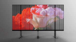 Fine pixel pitch transparent LED display on a freestanding frame, showing a vivid floral image.