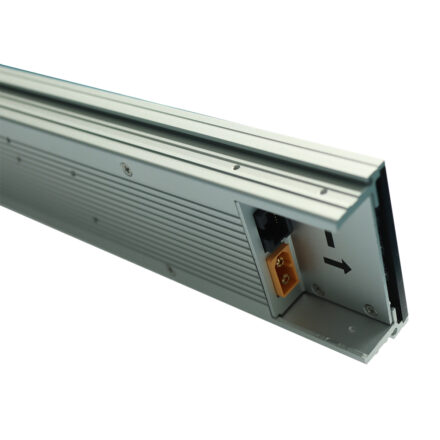 Angled elongated view of shelf-edge digital display panel showing extruded aluminium profile and end connector with power and data terminals.